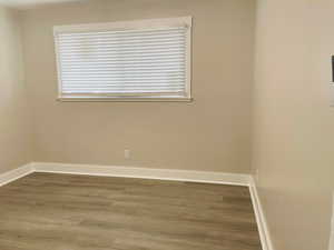 Bedroom with new flooring, paint, window and ceiling fan