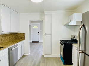 Featuring new cabinets, dishwasher, gas stove, range hood, lights and vinyl flooring