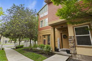 Entrance to property with stucco siding and stone siding
