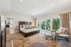 Carpeted bedroom with lofted ceiling and recessed lighting