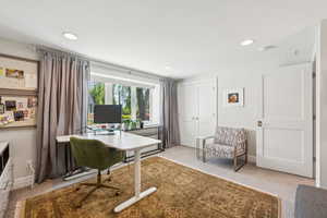 Office space with recessed lighting and light carpet