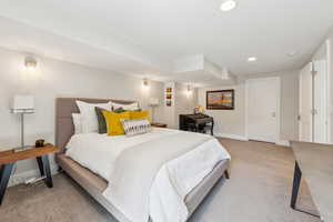 Bedroom featuring light carpet, recessed lighting, and baseboards
