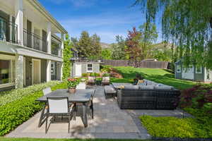 View of patio / terrace featuring a storage unit, an outdoor hangout area, an outdoor structure, and outdoor dining area
