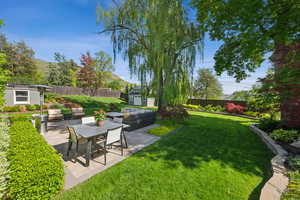 View of yard featuring a patio, a shed, an outbuilding, and an outdoor living space