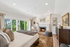 Bedroom with vaulted ceiling, a fireplace, recessed lighting, carpet, and baseboards