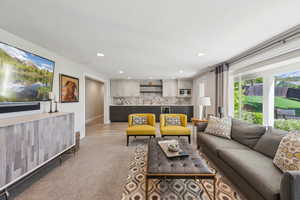 Living room with light carpet, baseboards, and recessed lighting