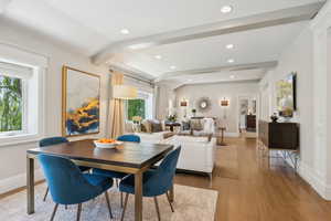Dining area featuring healthy amount of natural light, wood finished floors, beamed ceiling, baseboards, and recessed lighting