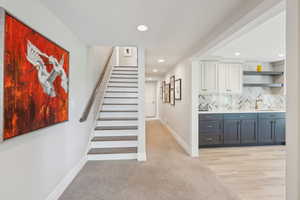 Stairway featuring recessed lighting, baseboards, carpet floors, and wet bar