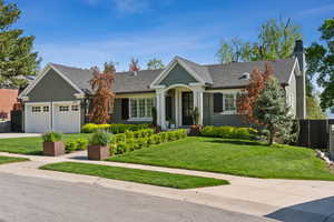 Ranch-style home with a garage, concrete driveway, a chimney, and roof with shingles
