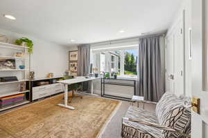 Office with recessed lighting and light colored carpet