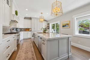 Kitchen featuring a sink, stainless steel appliances, a chandelier, plenty of natural light, and recessed lighting