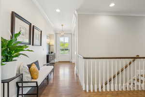 Hall featuring crown molding, wood finished floors, and recessed lighting