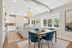 Dining room featuring a chandelier, light wood-type flooring, baseboards, and recessed lighting