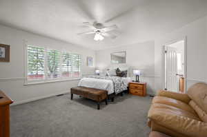 Bedroom featuring carpet floors, baseboards, and a ceiling fan