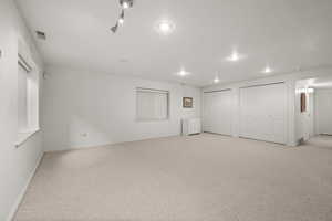 Basement featuring carpet, baseboards, and recessed lighting