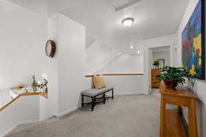 Sitting room featuring carpet floors, baseboards, and a textured ceiling