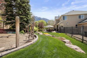View of yard with a mountain view, a patio, and fenced garden