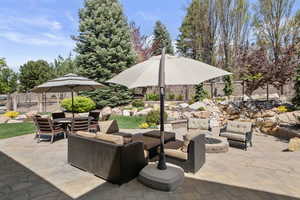 View of patio featuring an outdoor living space with a fire pit and water features