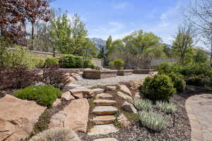 View of yard featuring a mountain view and fence