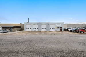 View of building exterior with a detached garage