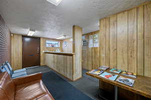 Welcome area with wood walls and a textured ceiling