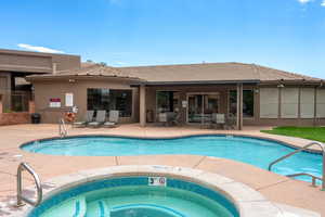 Community pool with a patio area and a community hot tub