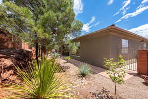 View of home's exterior with a gate and stucco siding