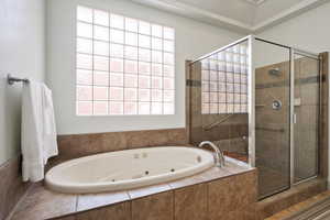 Bathroom featuring a stall shower and a jetted tub