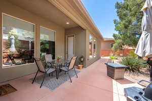 View of patio featuring fence and outdoor dining area