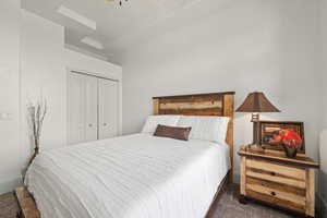 Bedroom featuring carpet and a closet