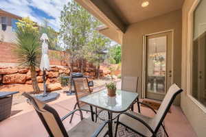 View of patio featuring fence and outdoor dining space