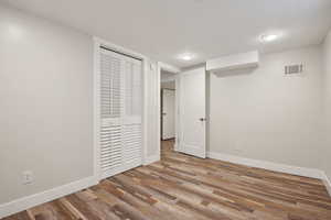 Finished basement featuring baseboards and wood finished floors