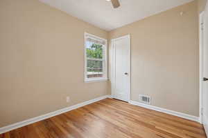 Empty room featuring baseboards, ceiling fan, and light wood finished floors