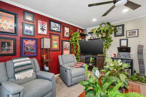 Living room featuring a ceiling fan, ornamental molding, baseboards, and recessed lighting