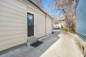 Doorway to property featuring a patio