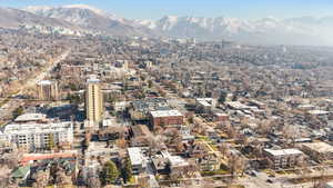 Aerial view of property and surrounding area with a mountain backdrop