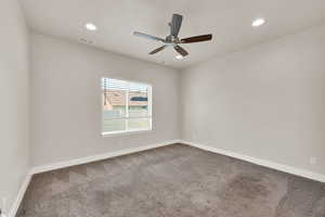Empty room with carpet floors, recessed lighting, baseboards, and a ceiling fan
