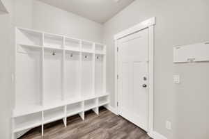 Mudroom featuring wood finished floors and baseboards