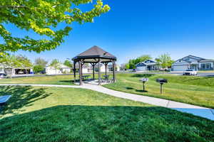 Surrounding community with a gazebo, a yard, and a residential view