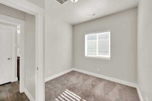 Carpeted spare room with baseboards