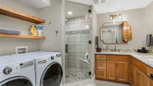 Laundry room featuring washer and dryer and recessed lighting