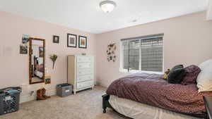 Bedroom featuring carpet floors and baseboards