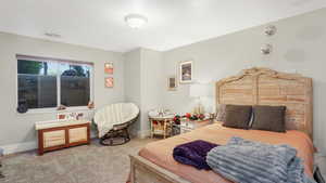 Carpeted bedroom with baseboards
