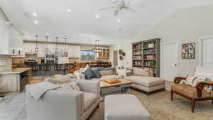Living room featuring ceiling fan, recessed lighting, a chandelier, and high vaulted ceiling