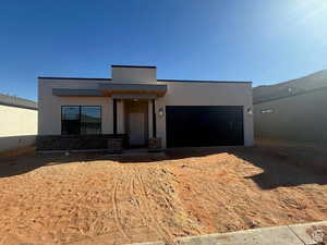 Contemporary house featuring stucco siding and a garage