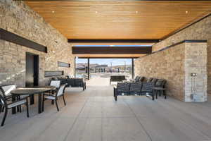 View of patio / terrace featuring an outdoor living space with a fireplace and outdoor dining area