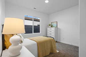 Carpeted bedroom featuring baseboards and recessed lighting