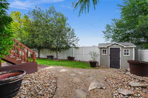 Fenced backyard with an outbuilding and a storage unit