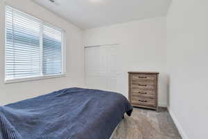 Carpeted bedroom featuring baseboards