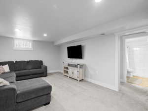 Living area featuring light carpet, recessed lighting, and baseboards